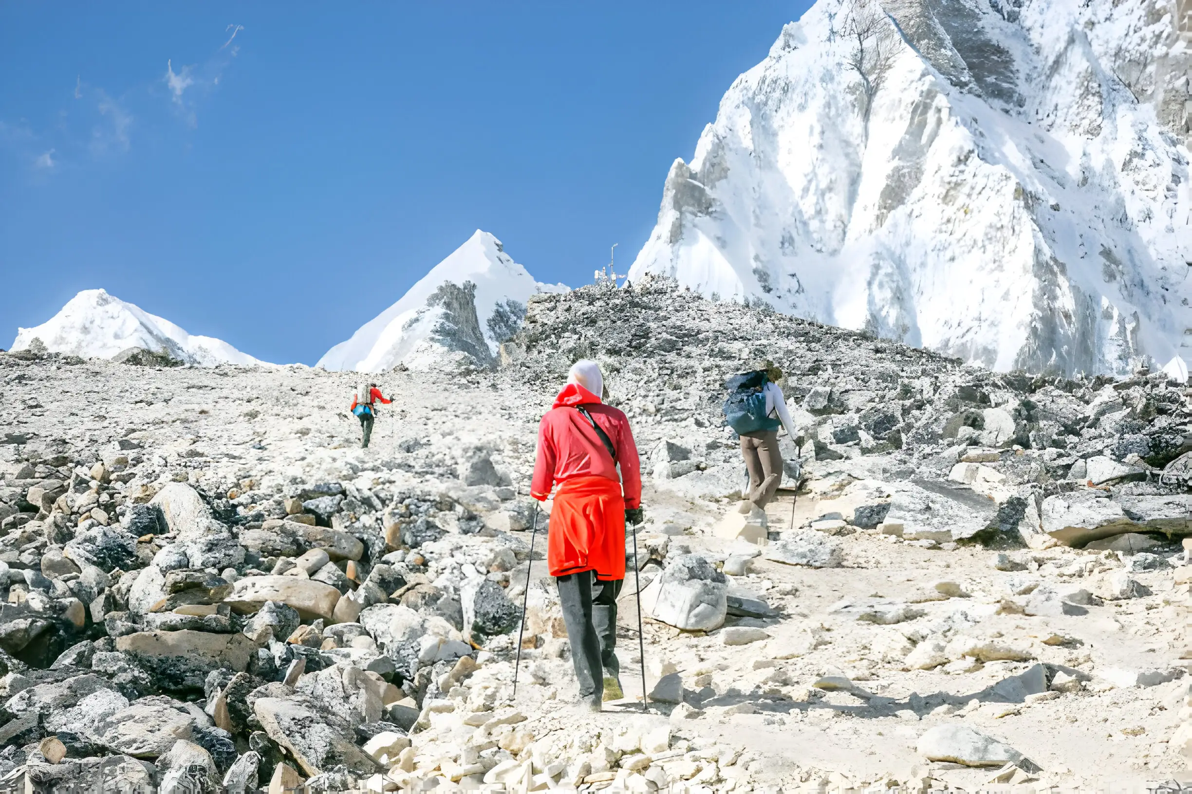 A Sherpa guide patiently assists novice trekkers through a rocky section of the EBC trail.