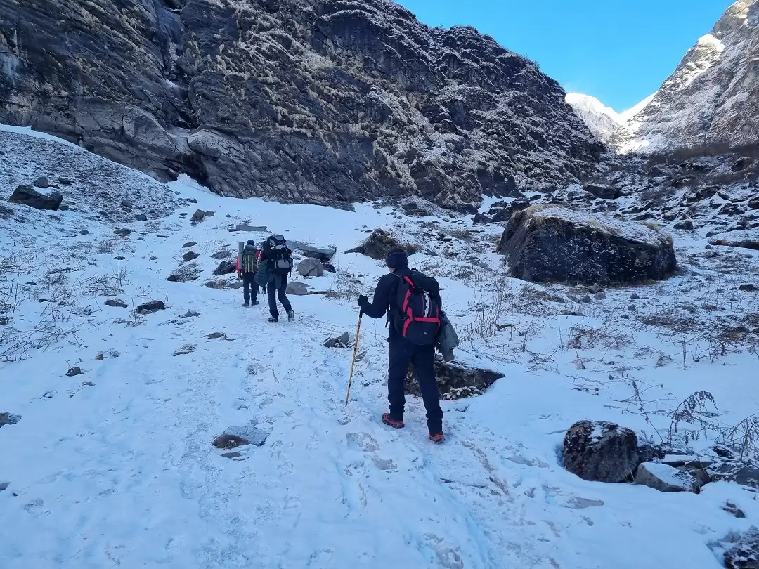 Rocky mountain trail with stone steps leading towards snow-covered peaks in the Annapurna region